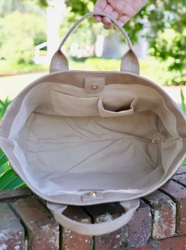 Beige patent handbag on sale